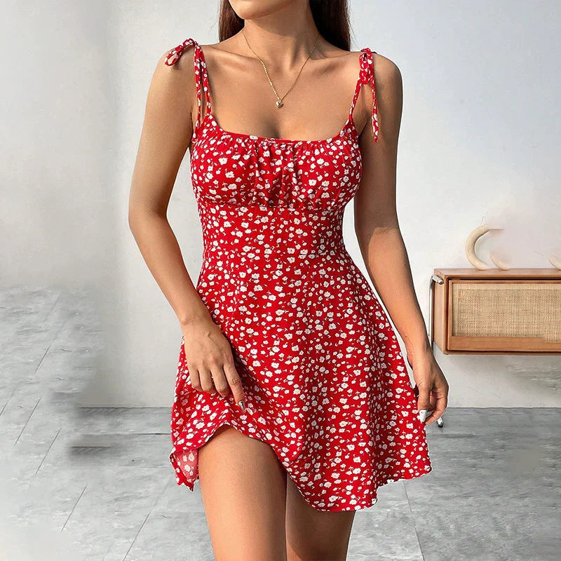 Woman wearing a red floral dress in an indoor setting