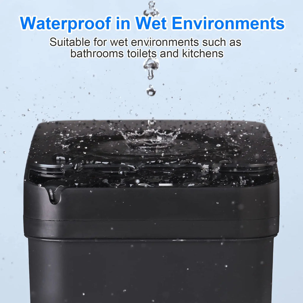 Close-up of a black motion sensor trash can with water droplets splashing onto the closed lid, demonstrating its waterproof design for wet environments like bathrooms.