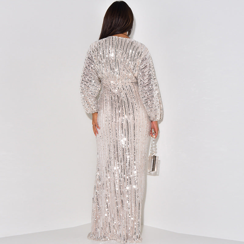 Person wearing a sparkling silver dress against a white background