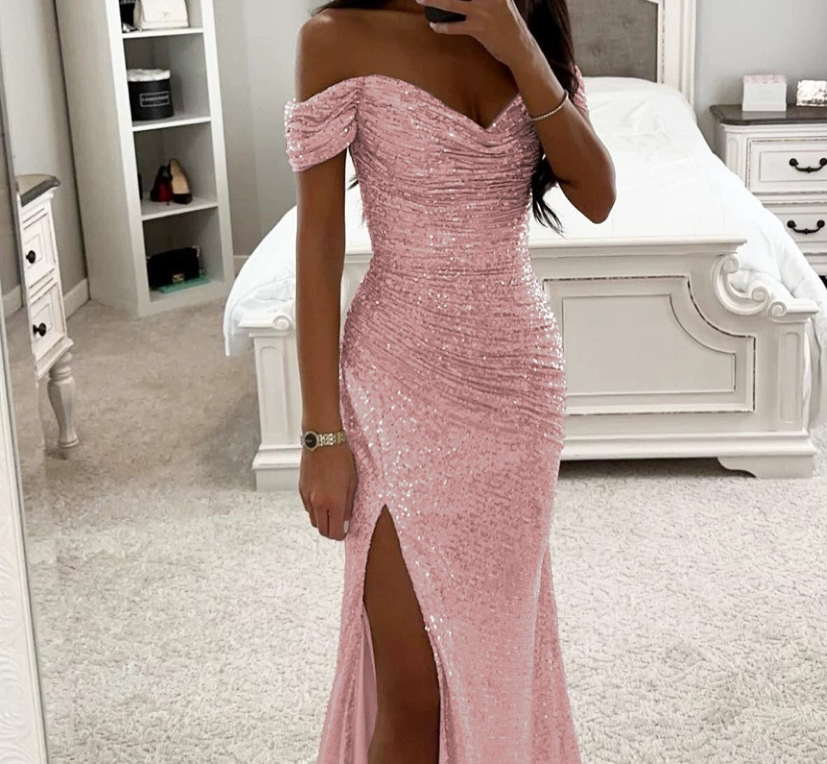 Person wearing a pink sequin dress in a bedroom setting