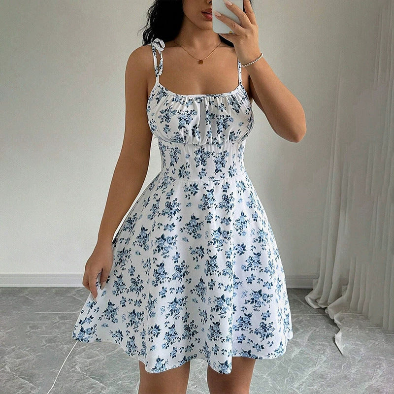 Woman wearing a white floral dress in a minimal indoor setting