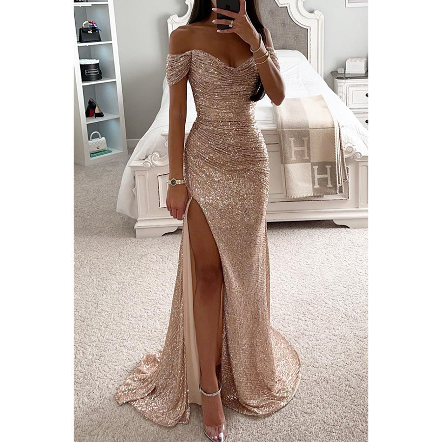 Woman wearing a sparkly off-shoulder evening gown in a bedroom setting.