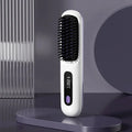 A white cordless hair straightener brush standing upright on a dark surface, featuring a digital LCD screen displaying 200°C for clear temperature visibility.