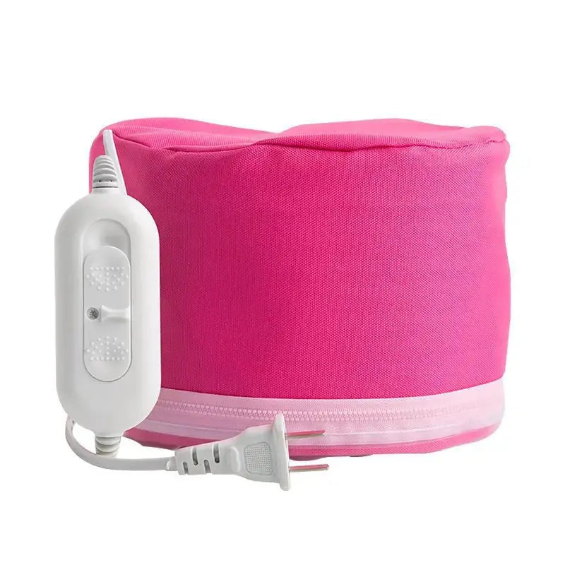 A vibrant pink electric heated hair conditioning cap shown from the side with its white zipper trim and attached white wired digital temperature remote control.
