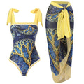 Blue and gold patterned swimsuit with matching sarong on a white background