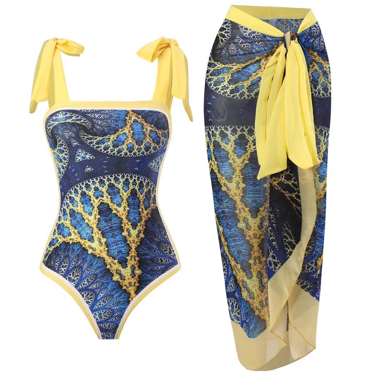 Blue and gold patterned swimsuit with matching sarong on a white background