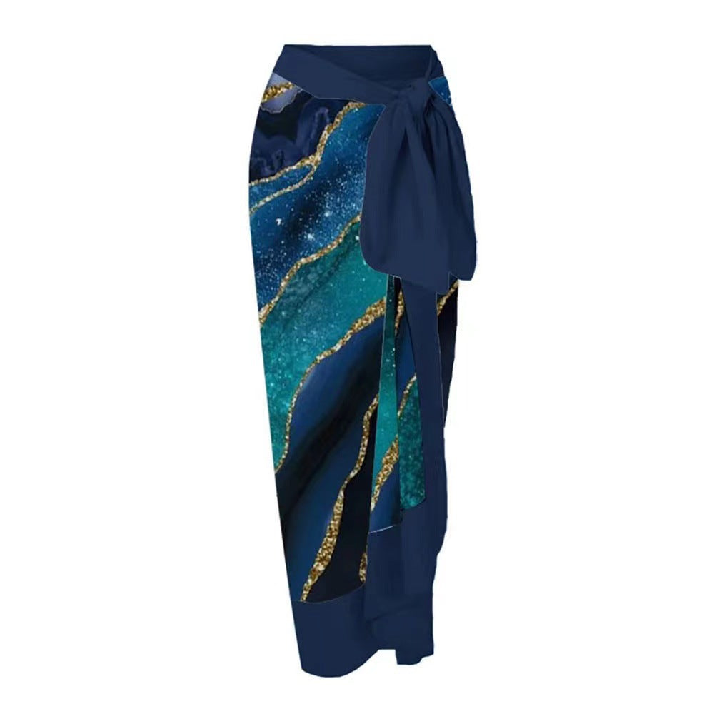 Navy blue skirt with teal and gold pattern on a white background