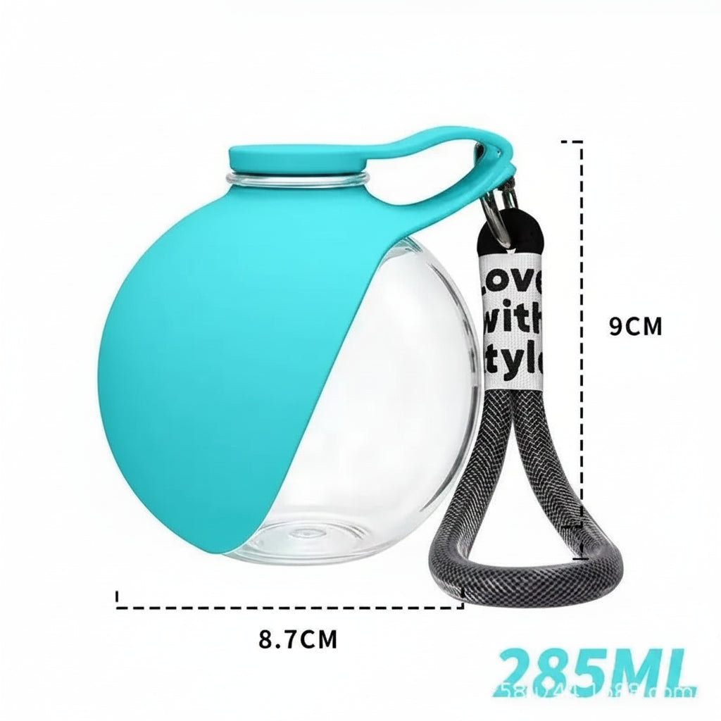 A clear stainless steel portable dog water bottle with a teal silicone bowl and black carry strap, featuring measurement graphics of 9cm width and 8.7cm depth to highlight its portable design.