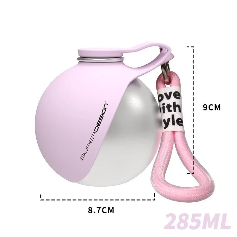 A pink stainless steel portable dog water bottle with a carry strap, featuring measurement overlays showing a 9cm width and 8.7cm depth for easy portioning and travel convenience.