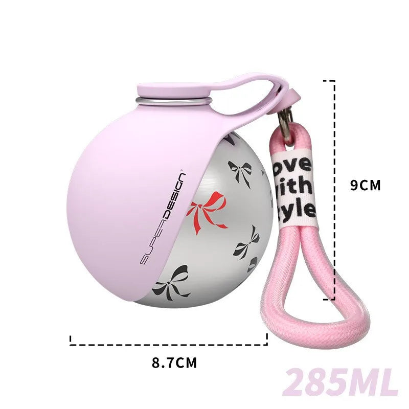 A pink stainless steel portable dog water bottle with a coordinating carry strap, featuring measurement overlays showing a 9cm width and 8.7cm depth for easy portioning and travel convenience.