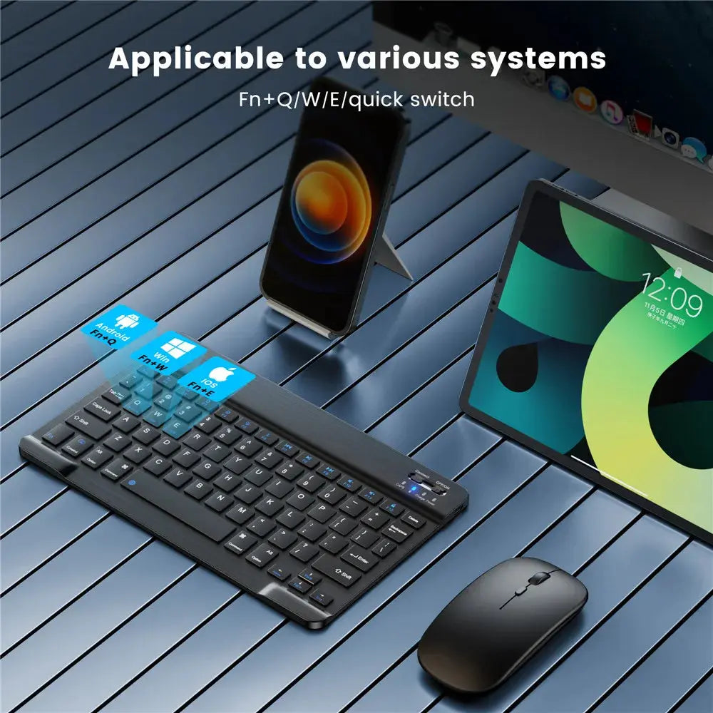 Keyboard and mouse set on a wooden surface with electronic devices in the background.