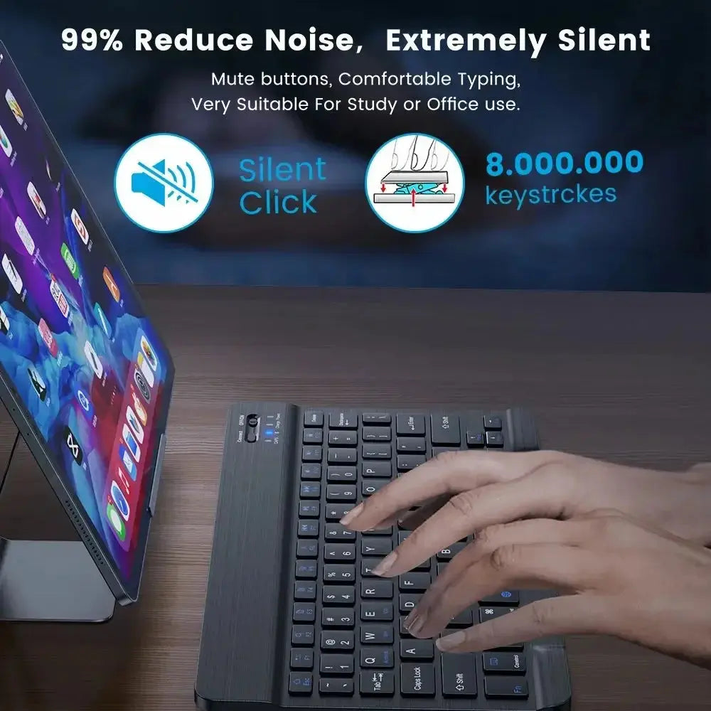 Person typing on a silent keyboard with a monitor in the background, emphasizing noise reduction and comfort.