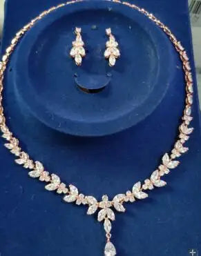 Necklace and earrings set on a blue surface