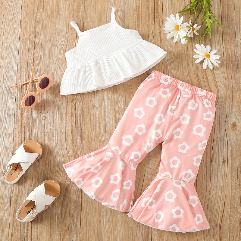 Children's white spaghetti-strap crop top and pink floral print flared pants summer outfit flat lay