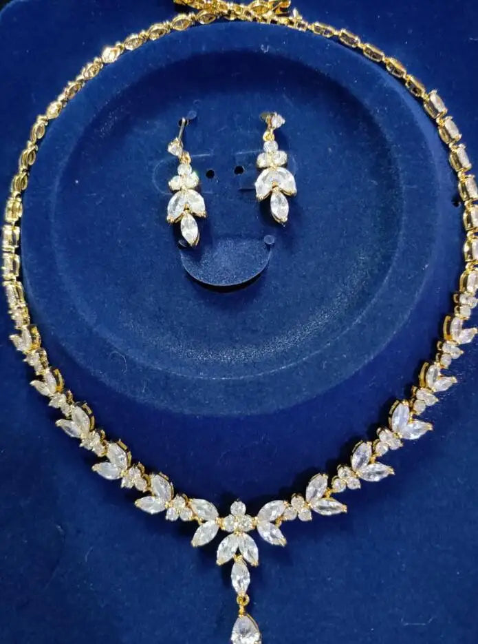 Jewelry set with necklace and earrings on a blue background