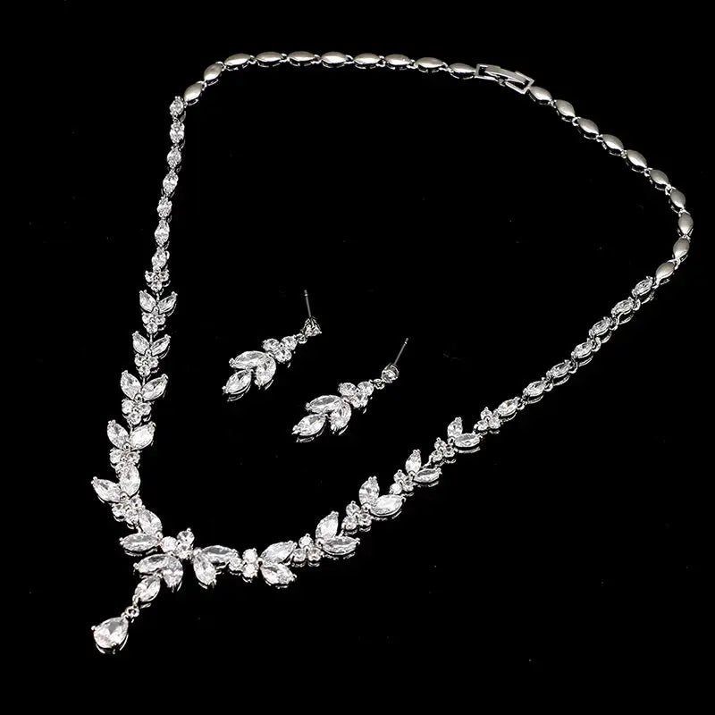 Silver jewelry set with necklace and earrings on a black background