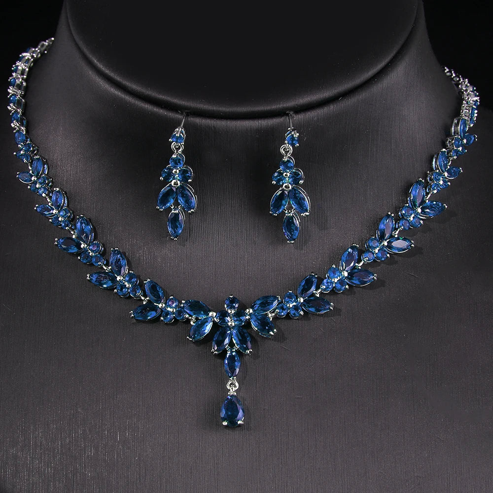 Blue gemstone necklace and earrings set on a black background