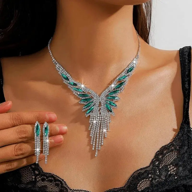 A luxurious tassel jewelry set with a crystal-encrusted necklace and matching drop earrings on a model wearing a black lace top.