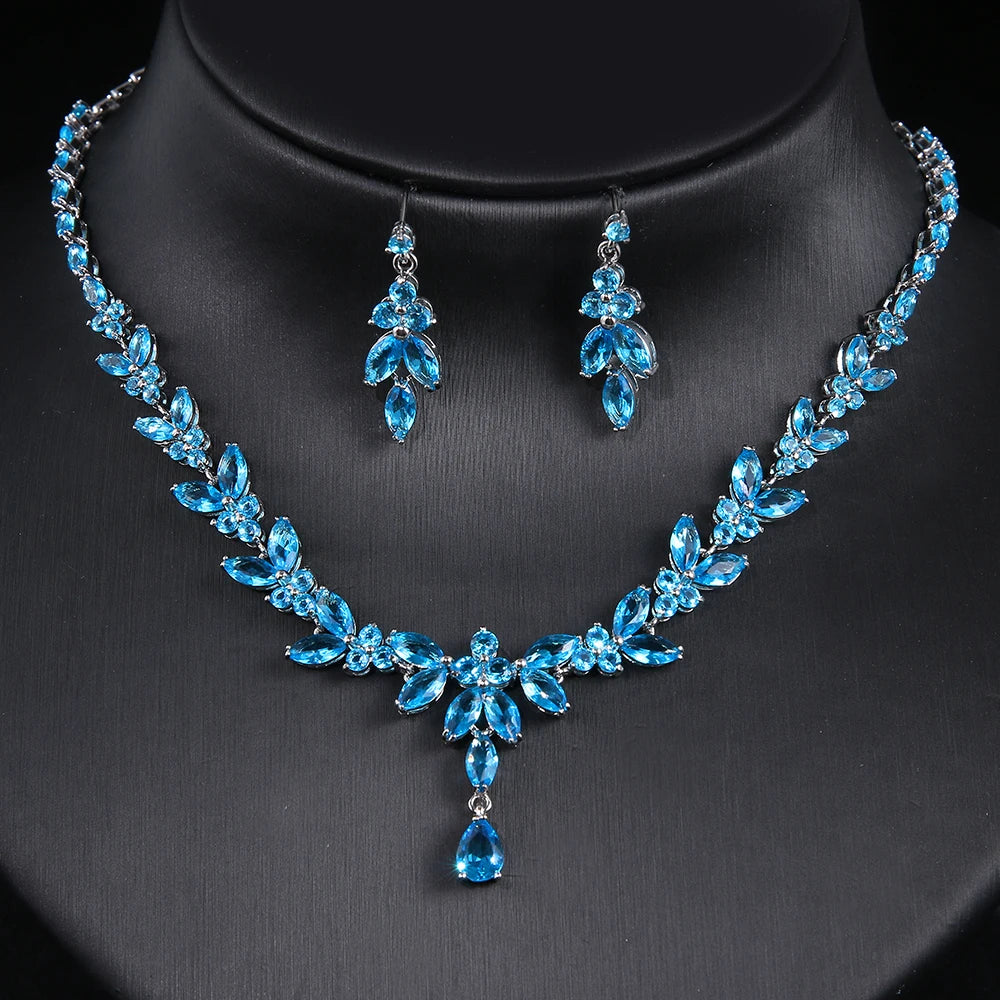 Blue jewelry set with necklace and earrings on a black background