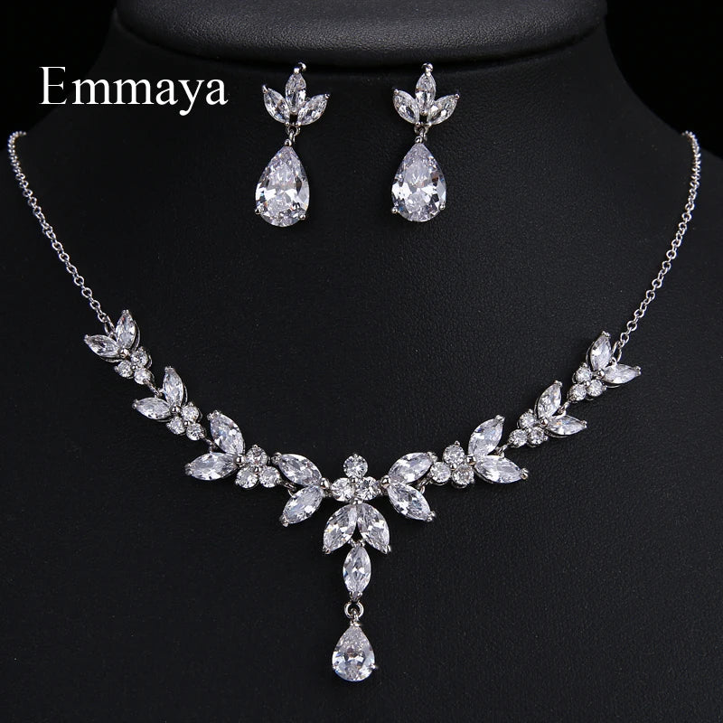 An ensemble shot of the cubic zirconia necklace and matching earrings laid flat on a neutral surface.