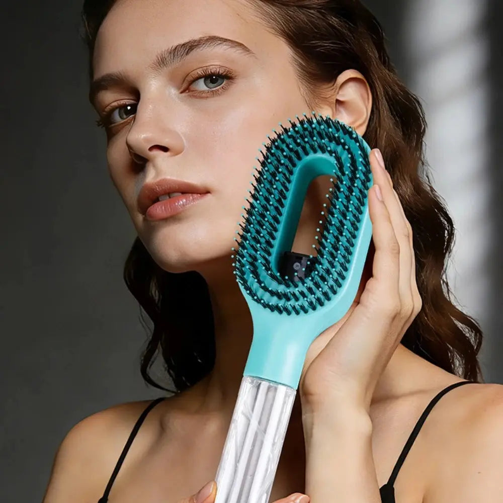 A woman holding a stylish blue and silver mist spray hair brush, showcasing the ergonomic design against a dark background.