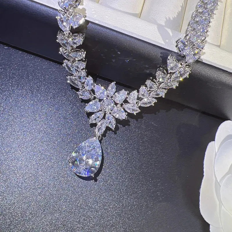 Side-profile shot of the moissanite jewelry set worn, showcasing the elegant design of the necklace and drop earrings.
