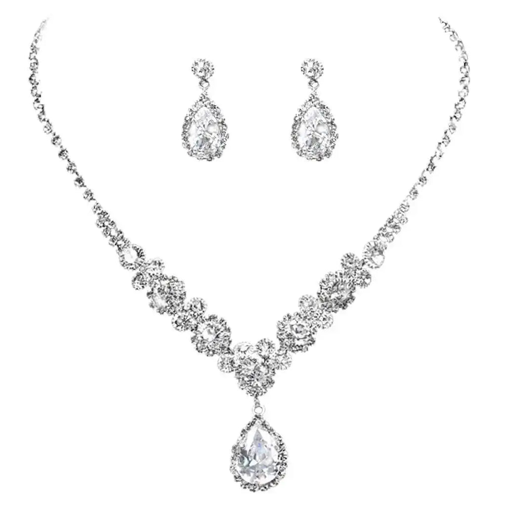 Silver necklace and earrings set on a white background