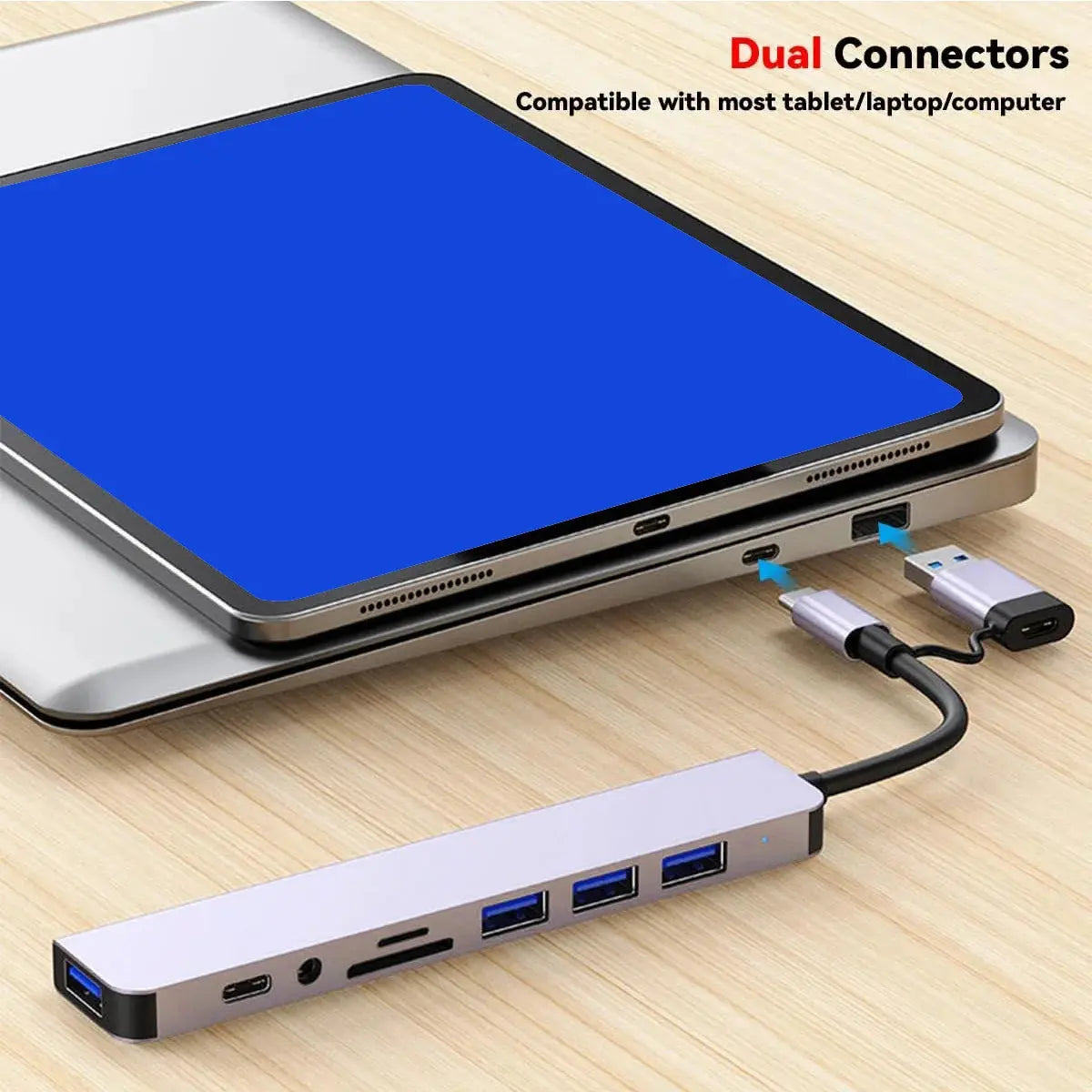 USB hub connected to a laptop with dual connectors on a wooden surface
