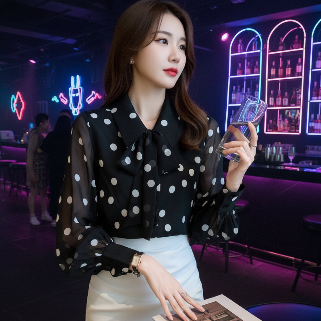 Side view of women's sleeveless printed bow-tie blouse