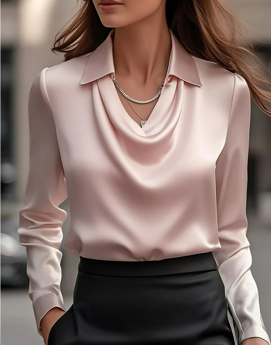 Front view of a woman wearing a soft pink silky satin blouse