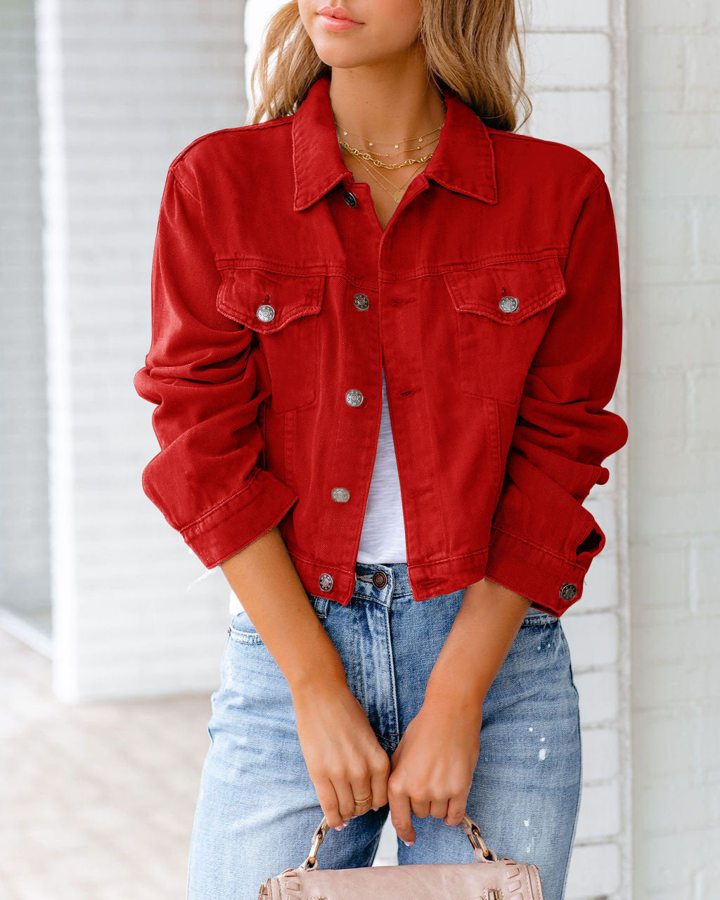 Young woman wearing the casual short denim jacket in red with lapel collar and button closure